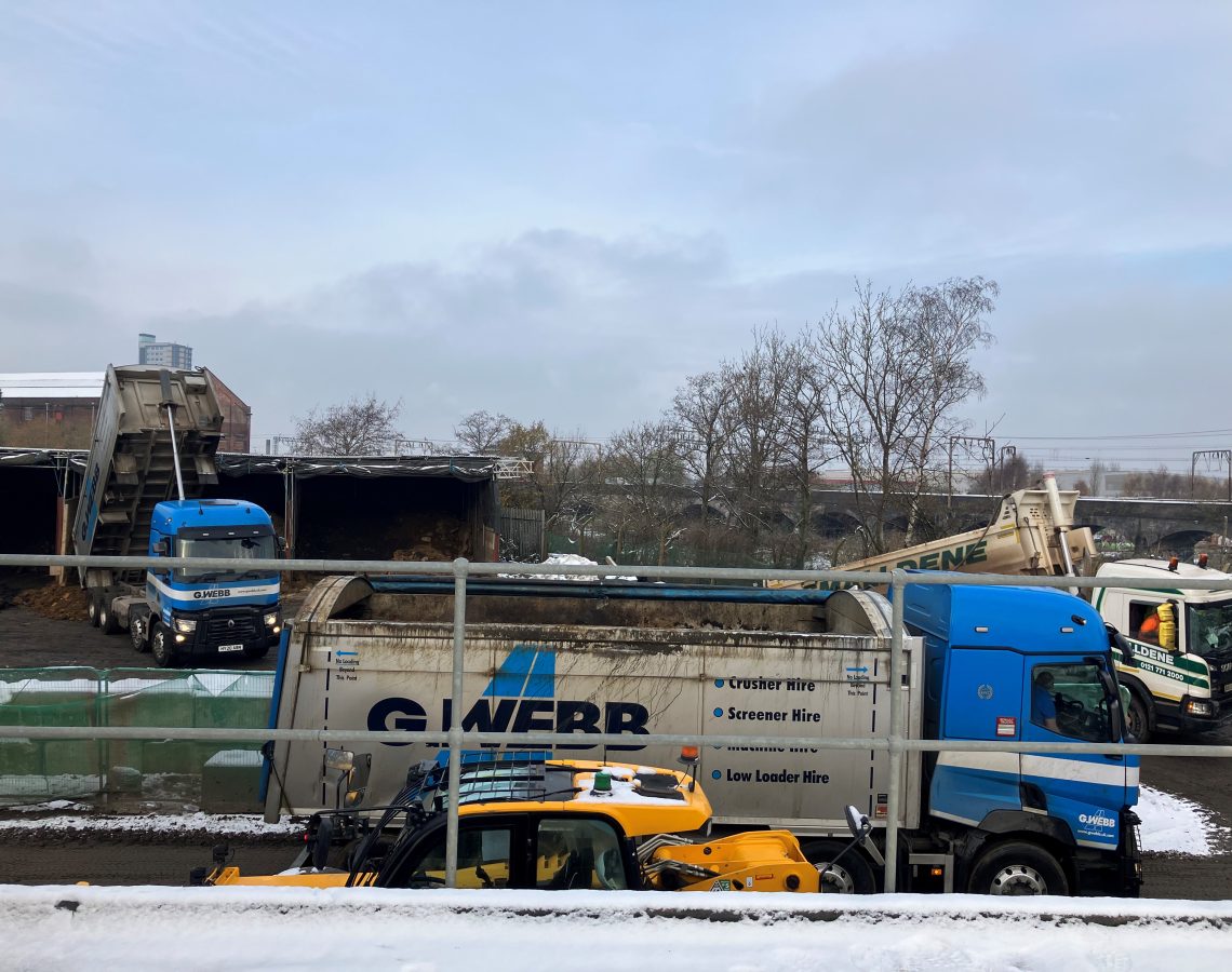 Trucks unloading asbestos